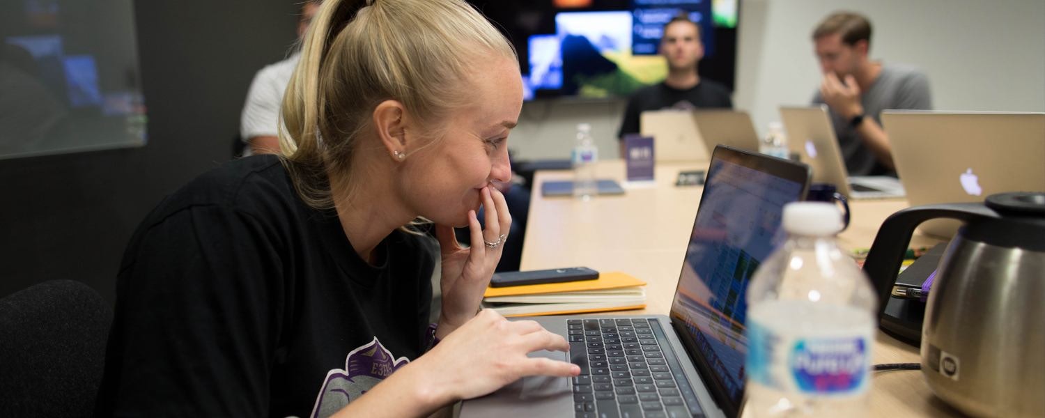 a female marketer updating paid media campaigns at her desk